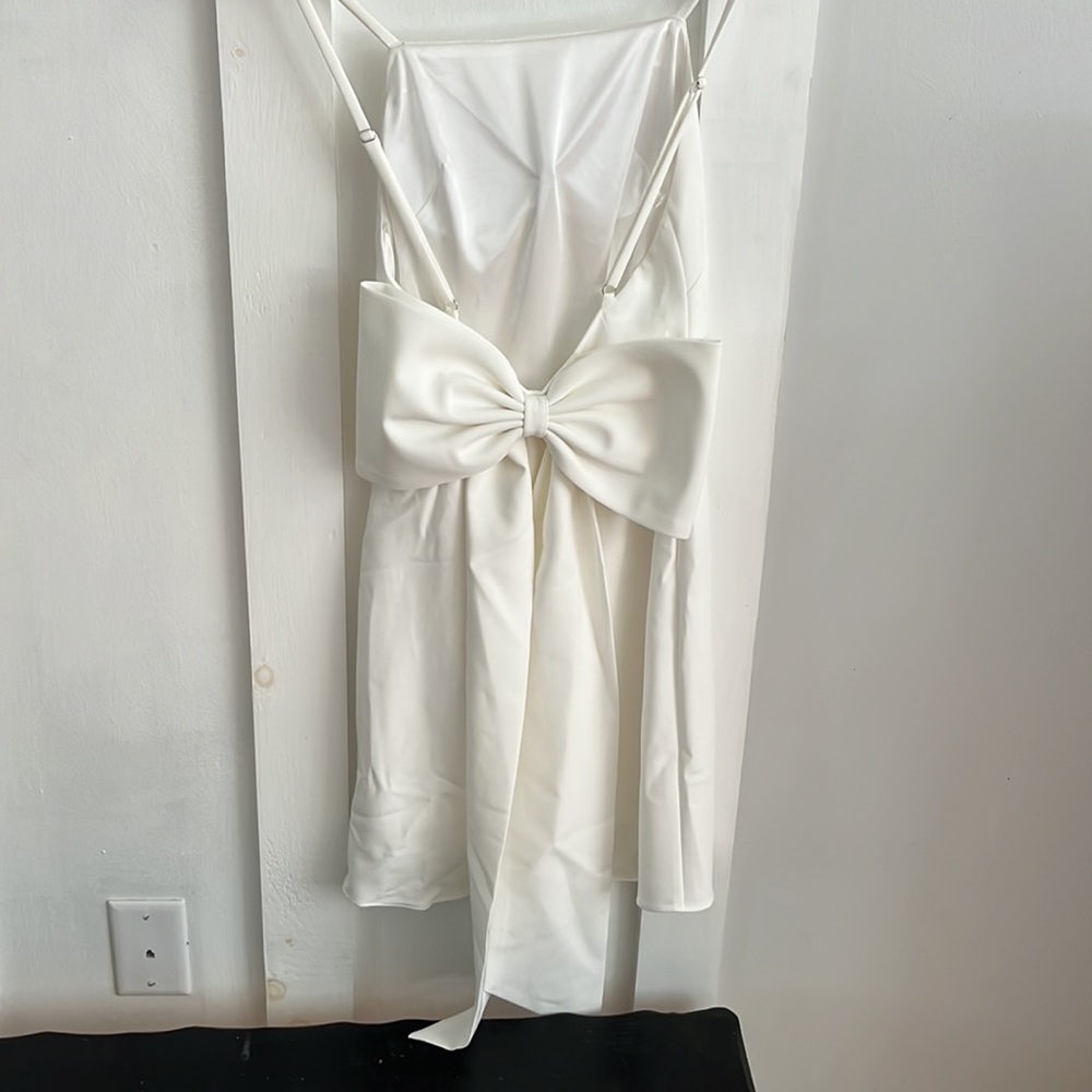 White slip dress with big bow on the bag!
